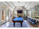 Bright community game room with a billiards table, stone fireplace, and large windows, offering a recreational space at 115 Batten Board Way Way, Woodstock, GA 30189