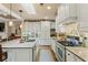 Modern kitchen featuring white cabinets, granite countertops, stainless steel appliances and hardwood floors at 115 Batten Board Way Way, Woodstock, GA 30189
