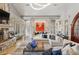 Grand living room with a stone fireplace, modern chandelier, and comfortable seating, ideal for entertaining guests at 115 Batten Board Way Way, Woodstock, GA 30189
