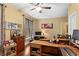Well-lit office space with hardwood floors, a large desk, and ample storage at 115 Batten Board Way Way, Woodstock, GA 30189