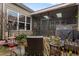 Outdoor patio area leading into an enclosed sunroom with a grill and an outdoor seating area at 115 Batten Board Way Way, Woodstock, GA 30189