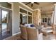 Beautiful outdoor patio with stone fireplace, plush seating, and access to the pool, creating an ideal retreat at 115 Batten Board Way Way, Woodstock, GA 30189