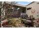 Cozy patio area next to an enclosed sunroom with a grill and seating area at 115 Batten Board Way Way, Woodstock, GA 30189