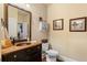 Charming powder room features a wooden countertop, copper sink, framed mirror, and neutral wall color at 115 Batten Board Way Way, Woodstock, GA 30189
