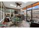 Enclosed sunroom features tiled floors, a fireplace, comfortable seating, and plenty of natural light at 115 Batten Board Way Way, Woodstock, GA 30189