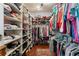 Spacious walk-in closet with custom shelving and hanging rods for optimal storage and organization at 115 Batten Board Way Way, Woodstock, GA 30189
