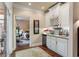 Wine rack, refrigerator, sink and view into bedroom with desk area at 115 Batten Board Way Way, Woodstock, GA 30189