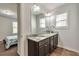 Bathroom vanity with granite countertops, modern lighting, and a framed mirror at 2021 Adam Acres Dr, Lawrenceville, GA 30043