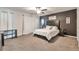 Cozy bedroom with carpeted floors, a ceiling fan, and dark accent wall at 2021 Adam Acres Dr, Lawrenceville, GA 30043