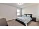 Simple bedroom featuring plush carpet and matching blue bedding and decor at 2021 Adam Acres Dr, Lawrenceville, GA 30043