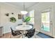 Cozy dining area with modern decor, table and chairs, and access to the outdoors at 2021 Adam Acres Dr, Lawrenceville, GA 30043