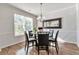 Cozy dining room featuring natural light, hardwood floors, and a modern chandelier at 2021 Adam Acres Dr, Lawrenceville, GA 30043