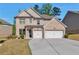 Charming two-story brick home featuring a spacious driveway and a two-car garage at 2021 Adam Acres Dr, Lawrenceville, GA 30043