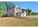 A two-story brick home featuring a two-car garage, well-maintained lawn, and landscaping at 2021 Adam Acres Dr, Lawrenceville, GA 30043