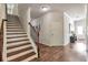 Hallway with hardwood floors, white trim, and a staircase leading to the upper level at 2021 Adam Acres Dr, Lawrenceville, GA 30043