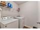 A practical laundry room with white washer and dryer and wire shelving at 2021 Adam Acres Dr, Lawrenceville, GA 30043
