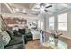 Open-concept living area with coffered ceiling, hardwood floors, and staircase access at 2021 Adam Acres Dr, Lawrenceville, GA 30043