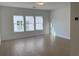 Bright bedroom featuring hardwood floors and multiple windows at 250 Mooney Rd, Woodstock, GA 30188