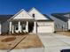 Charming, light brick home with manicured lawn and covered porch with columns at 250 Mooney Rd, Woodstock, GA 30188