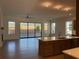 Open-concept living room featuring hardwood floors and sliding glass doors to backyard at 250 Mooney Rd, Woodstock, GA 30188