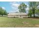 Spacious backyard with green grass, patio, and home with a metal roof at 85 Emily Trce, Covington, GA 30016