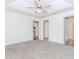 Bright bedroom with carpet flooring, ceiling fan, and ensuite bath and closet at 85 Emily Trce, Covington, GA 30016