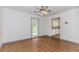 Well-lit dining area with hardwood floors, access to the kitchen, and a view of the backyard through the glass paneled door at 85 Emily Trce, Covington, GA 30016