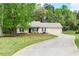 Charming single-story home featuring a metal roof, well-maintained lawn, and a paved driveway leading to an attached garage at 85 Emily Trce, Covington, GA 30016