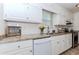 Bright kitchen with white cabinets, granite countertops, and stainless steel appliances for a modern cooking experience at 85 Emily Trce, Covington, GA 30016