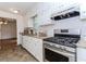 Well-equipped kitchen featuring white cabinets, granite countertops, and a stainless steel gas range for cooking convenience at 85 Emily Trce, Covington, GA 30016