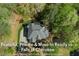 An aerial view of a landscaped home featuring a modern roof and lush surrounding greenery at 104 Kremer Falls Trce, Canton, GA 30114