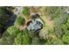 Bird's eye view of the property with mature trees, showcasing the home's roof and expansive surroundings at 104 Kremer Falls Trce, Canton, GA 30114