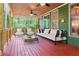 Relaxing back porch with comfortable seating, ceiling fans, and serene wooded views at 104 Kremer Falls Trce, Canton, GA 30114