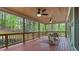 Relaxing covered porch with ceiling fans overlooking a lush, green backyard at 104 Kremer Falls Trce, Canton, GA 30114