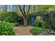 A quaint backyard with a fairy tale garden door and lush greenery creating a whimsical outdoor space at 104 Kremer Falls Trce, Canton, GA 30114