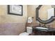Half bathroom with stone countertops, decorative mirror, and custom paint at 104 Kremer Falls Trce, Canton, GA 30114