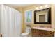 Bright bathroom features a marble countertop, framed mirror, decorative wall color, and ample natural light at 104 Kremer Falls Trce, Canton, GA 30114