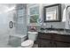 Bathroom featuring a marble shower and black granite countertop with a vanity at 104 Kremer Falls Trce, Canton, GA 30114
