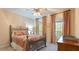 Bright bedroom with a metal frame bed, colorful bedding, and natural light at 104 Kremer Falls Trce, Canton, GA 30114