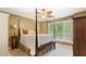 Bedroom features a four-poster bed, ceiling fan, and view of backyard at 104 Kremer Falls Trce, Canton, GA 30114