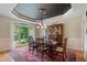 Traditional dining room featuring tray ceilings, detailed trim and molding, and large bay window at 104 Kremer Falls Trce, Canton, GA 30114