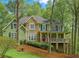 Charming two-story home with stone and green siding and a welcoming covered front porch at 104 Kremer Falls Trce, Canton, GA 30114