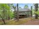 A beautiful two-story home surrounded by lush green trees, featuring a charming porch at 104 Kremer Falls Trce, Canton, GA 30114
