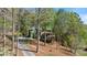 Picturesque two-story home with a welcoming front porch and lush, mature trees at 104 Kremer Falls Trce, Canton, GA 30114