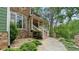 Stone and green siding with a covered porch and well-manicured landscaping welcomes you home at 104 Kremer Falls Trce, Canton, GA 30114