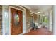 Inviting front porch with a wooden door, stone accents, and comfortable seating at 104 Kremer Falls Trce, Canton, GA 30114