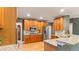 Well-lit kitchen with wood cabinets, stainless steel appliances, and granite countertops at 104 Kremer Falls Trce, Canton, GA 30114