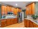Well-lit kitchen featuring stainless steel appliances and beautiful wooden cabinets and granite countertops at 104 Kremer Falls Trce, Canton, GA 30114