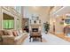 Cozy living room featuring a stone fireplace, a large window with backyard views, and hardwood floors at 104 Kremer Falls Trce, Canton, GA 30114