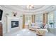 Inviting living room features a cozy fireplace, tray ceilings, and lots of natural light at 104 Kremer Falls Trce, Canton, GA 30114